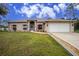 Single-story home with white garage door and landscaping at 4401 Boeing Ln, North Port, FL 34287