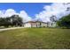 Single story house with attached garage and landscaping at 4401 Boeing Ln, North Port, FL 34287