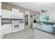 Kitchen with white cabinets, gray countertops, and modern appliances at 4401 Boeing Ln, North Port, FL 34287