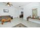 Living room with tiled floors, a plaid couch, and a coffee table at 4401 Boeing Ln, North Port, FL 34287