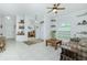 Spacious living room featuring tiled floors, built-in shelving, and a view to the home office at 4401 Boeing Ln, North Port, FL 34287