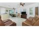 Spacious living room with brown leather reclining furniture and ceiling fan at 4401 Boeing Ln, North Port, FL 34287