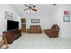 Spacious living room with brown leather reclining furniture and ceiling fan at 4401 Boeing Ln, North Port, FL 34287