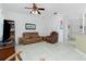 Spacious living room with brown leather reclining furniture and ceiling fan at 4401 Boeing Ln, North Port, FL 34287