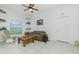 Living room with tiled floors, a plaid couch, and a coffee table at 4401 Boeing Ln, North Port, FL 34287