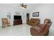 Spacious living room with brown leather reclining furniture and ceiling fan at 4401 Boeing Ln, North Port, FL 34287