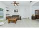 Living room with tiled floors, a plaid couch, and a coffee table at 4401 Boeing Ln, North Port, FL 34287