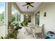 Enjoy this screened porch with outdoor seating and ceiling fan at 4401 Boeing Ln, North Port, FL 34287