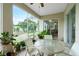 Bright screened porch with glass sliding doors and outdoor furniture at 4401 Boeing Ln, North Port, FL 34287