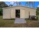 Tan colored storage shed with double doors and ramp at 4401 Boeing Ln, North Port, FL 34287