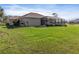 Spacious backyard with a screened enclosure and lush lawn at 45 Marker Rd, Rotonda West, FL 33947