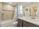 Bright bathroom with shower/tub, vanity, and beach themed decor at 45 Marker Rd, Rotonda West, FL 33947