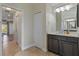 Bathroom with dark wood vanity and access to bedroom at 45 Marker Rd, Rotonda West, FL 33947