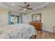 Bedroom with wood flooring, sliding doors to patio, and ceiling fan at 45 Marker Rd, Rotonda West, FL 33947