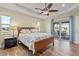 Bedroom with wood flooring, sliding doors to patio, and ceiling fan at 45 Marker Rd, Rotonda West, FL 33947