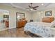 Bright bedroom with wood flooring, access to kitchen and ceiling fan at 45 Marker Rd, Rotonda West, FL 33947