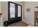 Bright entryway with double black doors and a decorative compass at 45 Marker Rd, Rotonda West, FL 33947