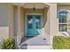 Inviting teal front door with glass panels and a small porch at 45 Marker Rd, Rotonda West, FL 33947