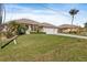 Two-story house with a two-car garage and lush landscaping at 45 Marker Rd, Rotonda West, FL 33947