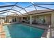 Large pool with screened enclosure and patio furniture at 45 Marker Rd, Rotonda West, FL 33947