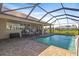 Spacious pool and patio area with screened enclosure at 45 Marker Rd, Rotonda West, FL 33947