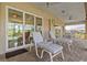 Covered patio with glass doors overlooking the pool and lanai at 45 Marker Rd, Rotonda West, FL 33947