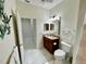 Bathroom with granite vanity, toilet and access to other rooms at 4530 Turnberry Cir, North Port, FL 34288