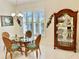 Dining room with glass table, chairs, and china cabinet at 4530 Turnberry Cir, North Port, FL 34288