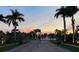 Gated community entrance with palm trees and sunset view at 4530 Turnberry Cir, North Port, FL 34288