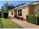 Brick walkway leading to a tan house with large windows at 4530 Turnberry Cir, North Port, FL 34288