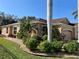 Front exterior of tan house with stone accents and landscaping at 4530 Turnberry Cir, North Port, FL 34288