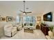 Bright living room with comfy seating and large windows at 4530 Turnberry Cir, North Port, FL 34288