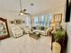 Relaxing living room with white leather sofas and a TV at 4530 Turnberry Cir, North Port, FL 34288