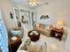 Sitting room with sofa, armchairs, and access to kitchen at 4530 Turnberry Cir, North Port, FL 34288