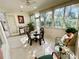 Relaxing sunroom featuring wicker furniture and large windows at 4530 Turnberry Cir, North Port, FL 34288