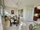 Bright sunroom with glass table and chairs, offering access to the kitchen at 4530 Turnberry Cir, North Port, FL 34288