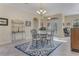 Dining area with glass-top table, four chairs and access to the backyard at 4607 Sabrina Ter, North Port, FL 34286