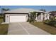 Light gray house with a white garage door and a nicely landscaped yard at 4607 Sabrina Ter, North Port, FL 34286