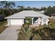 One-story house with light gray exterior, white garage door, and palm trees at 4607 Sabrina Ter, North Port, FL 34286