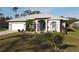 One-story home with light gray exterior, white garage door, and landscaped yard at 4607 Sabrina Ter, North Port, FL 34286