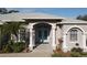 Front entrance with light blue double doors and white columns at 4607 Sabrina Ter, North Port, FL 34286