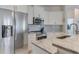 Bright kitchen featuring stainless steel appliances and white cabinets at 4607 Sabrina Ter, North Port, FL 34286