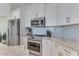 White kitchen with stainless steel appliances and granite countertops at 4607 Sabrina Ter, North Port, FL 34286