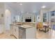 Open concept kitchen and dining area with breakfast bar and view of backyard at 4607 Sabrina Ter, North Port, FL 34286