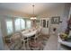 Elegant dining room with a large table, chandelier, and built-in hutch at 506 Monaco Dr, Punta Gorda, FL 33950