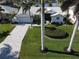 Aerial view of a house with a paved driveway and palm trees at 506 Monaco Dr, Punta Gorda, FL 33950