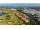 Aerial view showcasing the property's location near a golf course and waterway at 5089 San Rocco Ct, Punta Gorda, FL 33950