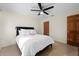 Bedroom with queen bed, ceiling fan, and wood closet doors at 5089 San Rocco Ct, Punta Gorda, FL 33950