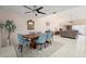 Elegant dining room with a wooden table and blue chairs, open floor plan at 5089 San Rocco Ct, Punta Gorda, FL 33950