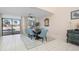 Bright dining room with wooden table and blue chairs, view of pool at 5089 San Rocco Ct, Punta Gorda, FL 33950